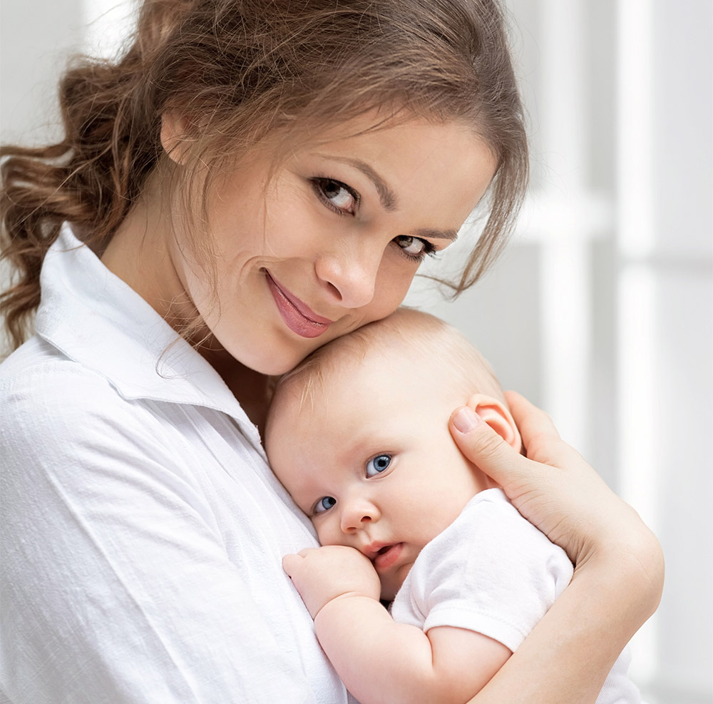 Man and woman close together, woman looking at camera smiling