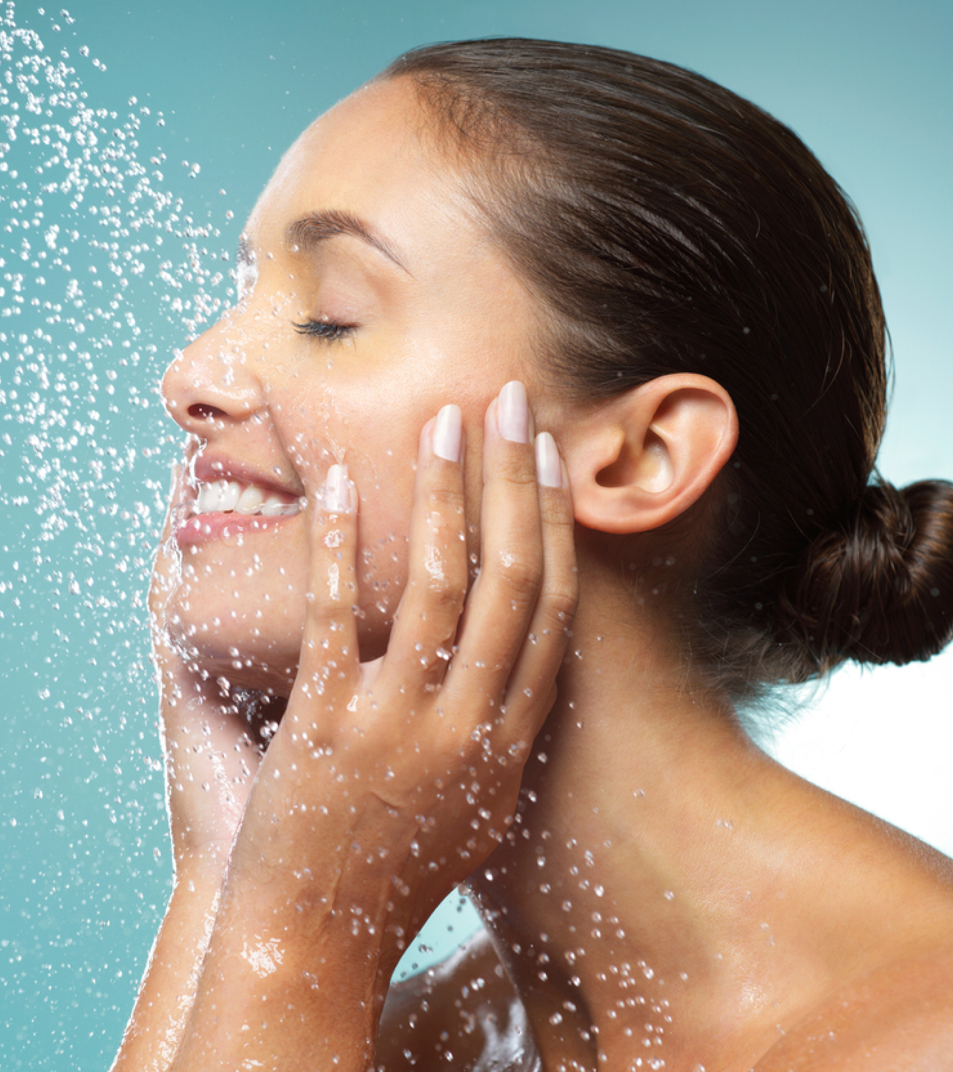 Smiling woman washing her face